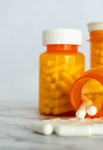 empty capsules in orange PET bottles for medicine storage